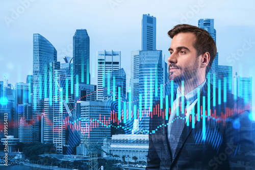 A young Caucasian handsome trader and stock market analyst in suit dreaming about market behavior and forecast in crisis. Trading at corporate finance fund. Forex chart. Singapore. Double exposure