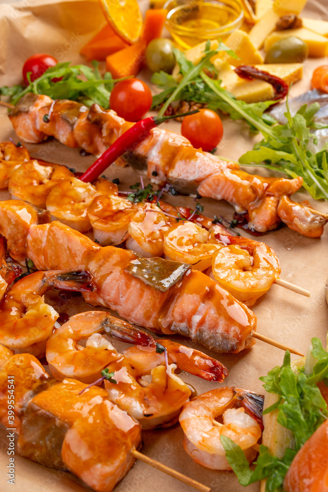 seafood skewers in sauce. Yakitori. Grilled tiger shrimps and salmon on skewers seafood skewers in sauce. Yakitori. Grilled tiger shrimps and salmon on skewers