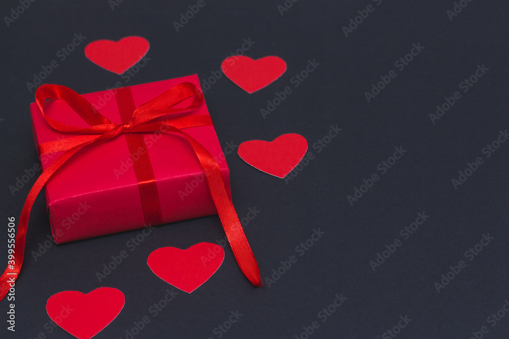 valentine's day concept. stylish red present and hearts on black background. happy valentines day. greeting card.