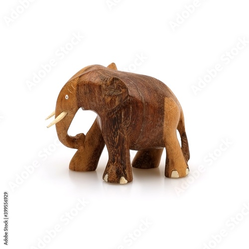 Wooden souvenir elephant made of wood and ivory isolated on a white background © Elena