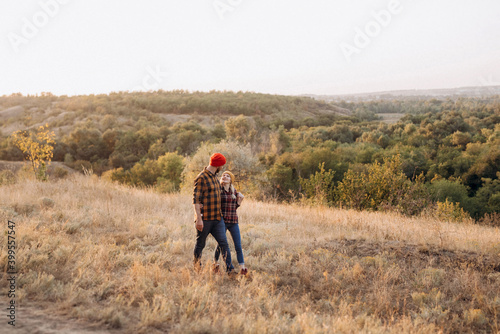 Cheerful guy and girl on a walk in bright knitted hats © omelnickiy