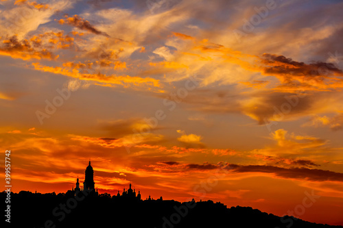 Silhouette the Kiev monastery against the orange sky.