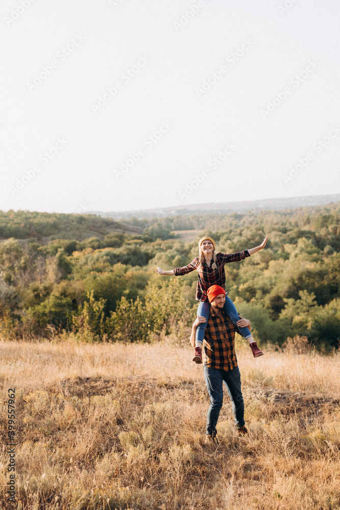 Cheerful guy and girl on a walk in bright knitted hats