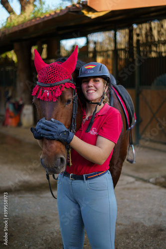 Chica hipica montando a caballo ecuestre en club de monta caballo andaluz cadiz doma clasica vaquera photo