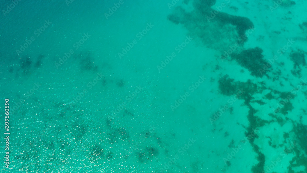 Fototapeta premium Sea water surface in lagoon, copy space for text, aerial view. Top view transparent turquoise ocean water surface. background texture
