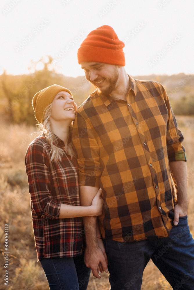 Cheerful guy and girl on a walk in bright knitted hats Cheerful guy and girl on a walk in bright knitted hats