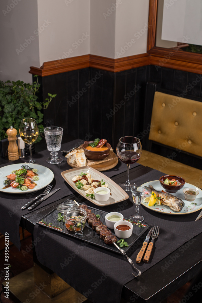 dining table food set with appetizer and drinks in restaurant