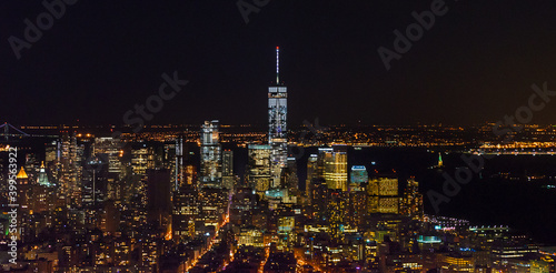 Breathtaking Panoramic and Aerial View of Manhattan, New York City at Night. Beautiful, Illuminated, Futuristic Buildings. Freedom Tower, Lady Liberty Statue, Hudson River.