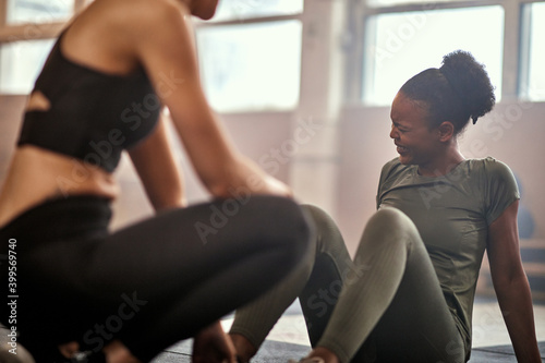 Woman laughing after workout with a partner in a gym