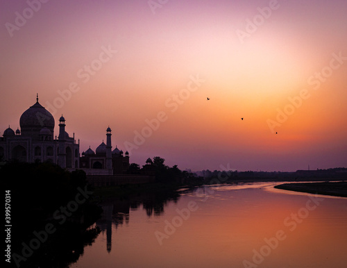 sunset over the river beside taj mahal  © Henrique
