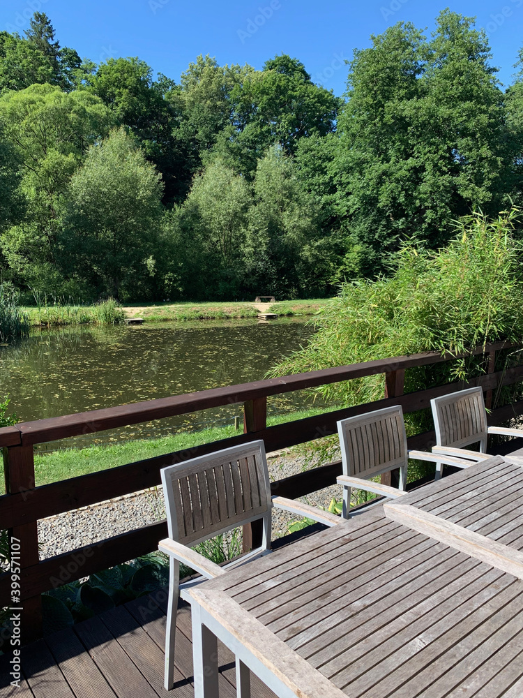 Wooden table and chairs on the lake shore