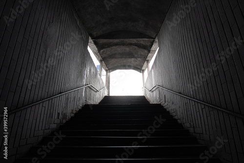 Stairs to the dark underpass, entrance to the dark underpass, view from inside.