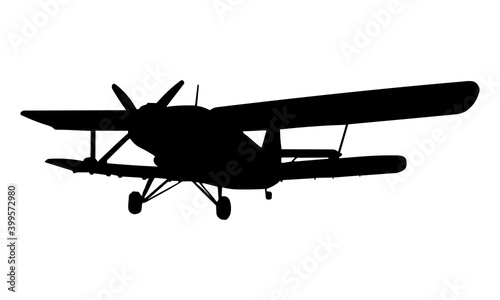 Fototapeta Naklejka Na Ścianę i Meble -  the silhouette of the beauty of the double-wing aircraft in the air