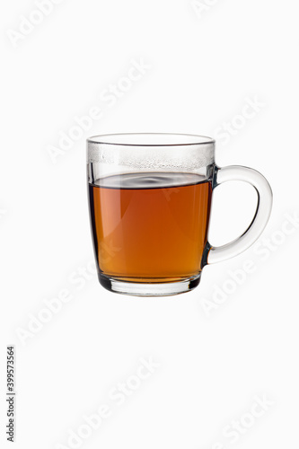 Tea in a transparent glass mug on a white background