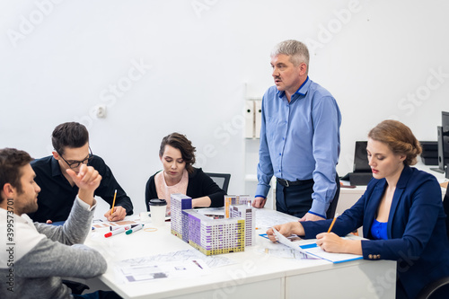 A senior manager meeting with his young team.