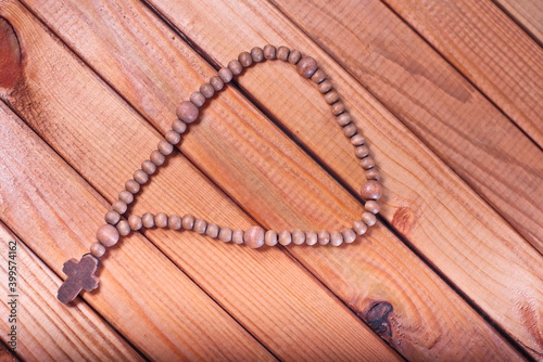 wooden rosary on wooden background