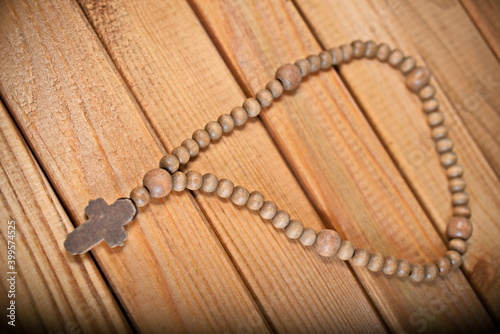 wooden rosary on wooden background