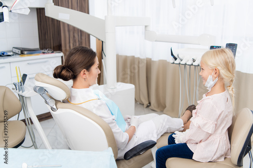 Kids at hospital  Little doctors  playing a dentist. The girl and the dentist have switched positions.