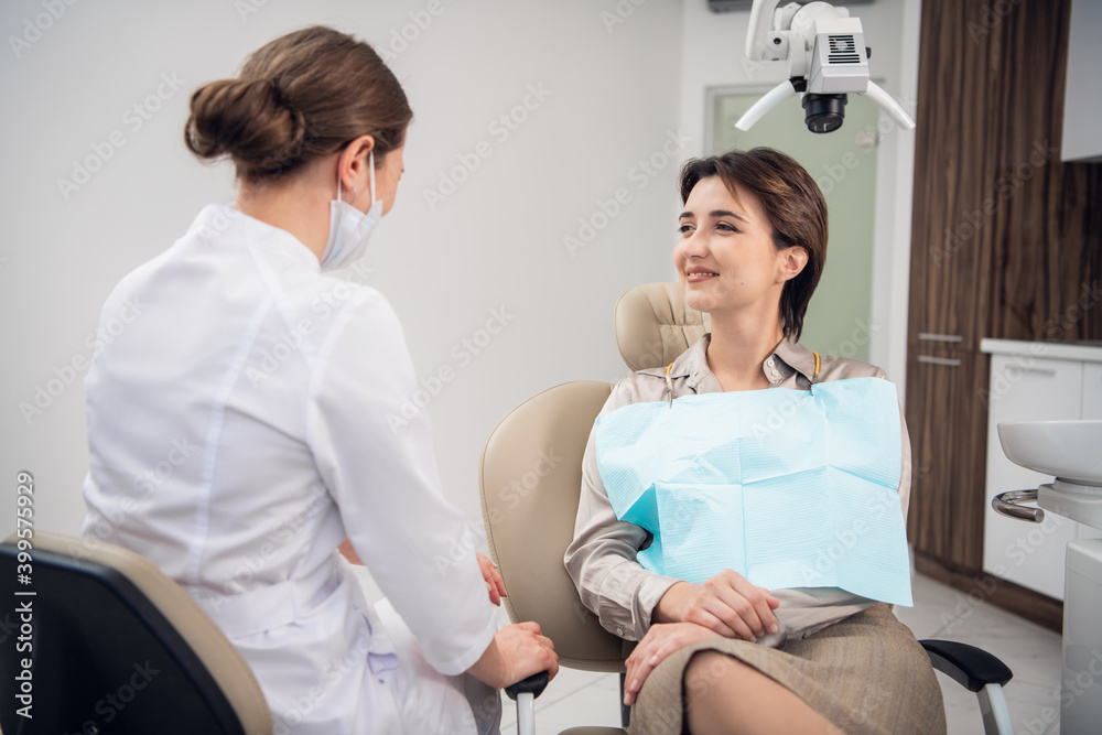 Closeup portrait of a smiling happy patient in adental clinic. Peventive medical annual check up. Positive facial expression. Closeup portrait of a smiling happy patient in adental clinic. Peventive medical annual check up. Positive facial expression.