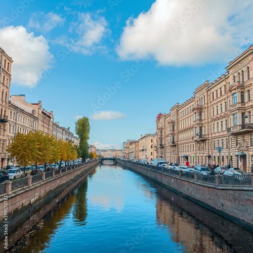 view of the Fontanka canal with beautiful houses on the shore against the blue sky © westermak15