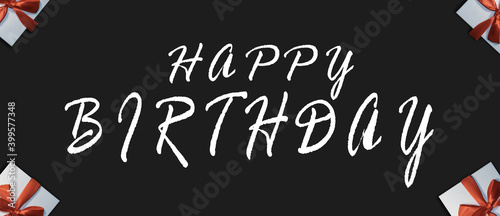 Happy Birthday. Black Background with congratulatory text. Gifts in the background