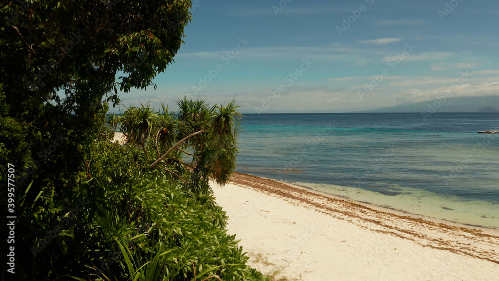 Tropical island in the blue sea with coral reef, top view. Small island with sandy beach. Summer and travel vacation concept, Mantigue island, Philippines, Mindanao Tropical island in the blue sea with coral reef, top view. Small island with sandy beach. Summer and travel vacation concept, Mantigue island, Philippines, Mindanao
