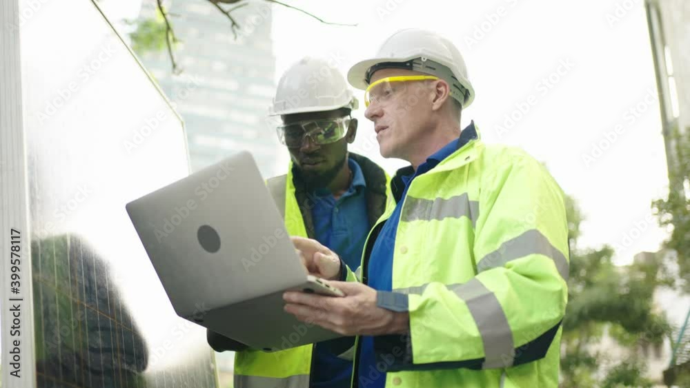 Engineer and workman handshake of alternative energy at the site,solar panels,controller box.green renewable energy and sustainability development energy concept. Engineer and workman handshake of alternative energy at the site,solar panels,controller box.green renewable energy and sustainability development energy concept.
