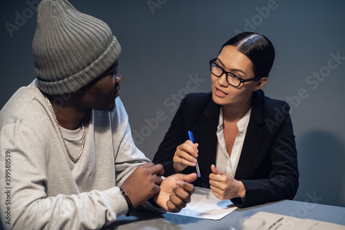 Tableau sur toile A pretty lawyer girl is having a conversation with a drug dealer client at the police station