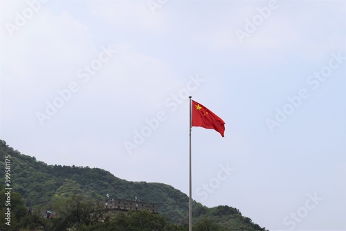 A Waving China Flag Standing at the Great Wall Beijing China