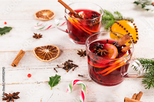 Mulled wine with cinnamon sticks and orange slices, Christmas background. Top view.