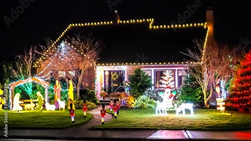 Small American home exterior decorated with colorful festive holiday lights