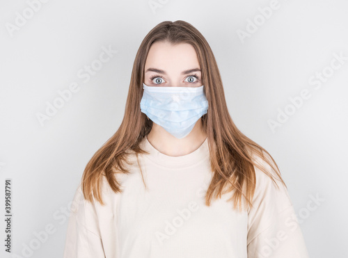 Close-up portrait of attractive girl wear facial mask to protect against flu or cold, isolated over white background