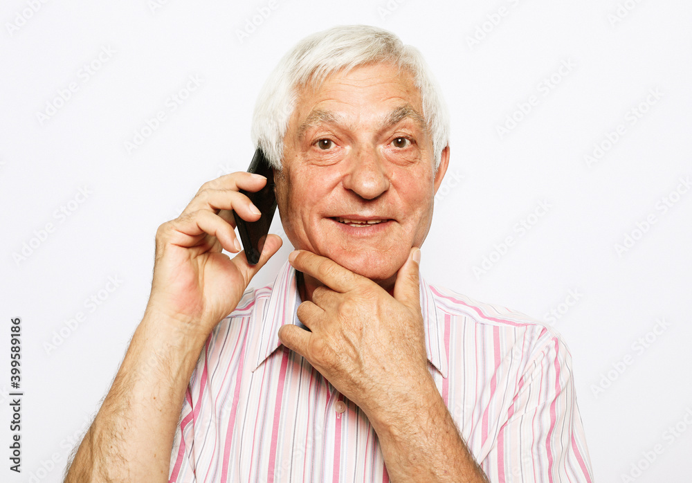 Old active man with mobile phone isolated on white background Old active man with mobile phone isolated on white background