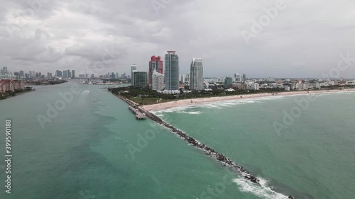 Aerial footage of Miami South Beach and South Pointe Park Pier on cloody day. Drone side shot. photo