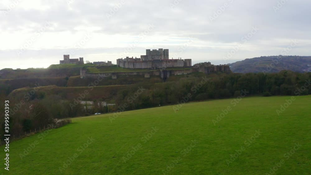 Dolly forward drone shot over farm land over Dover Castle towards city and port UK Dolly forward drone shot over farm land over Dover Castle towards city and port UK