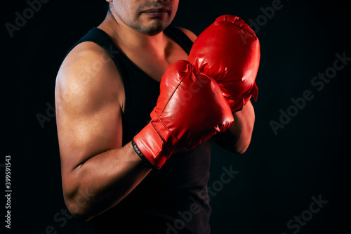 Brown skinned latino male boxer uses boxing gloves to exercise and train for boxing