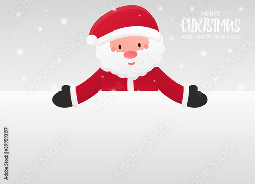 Santa Claus peeps out from behind a blank white background and points with two hands at him. Blank space for your holiday text. Cold and snowy winter. Merry Christmas and a Happy New Year. Banner. © Dreykon