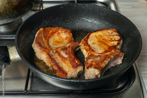 Grilled pork cutlets in a pan. Organic meat steak. White background.