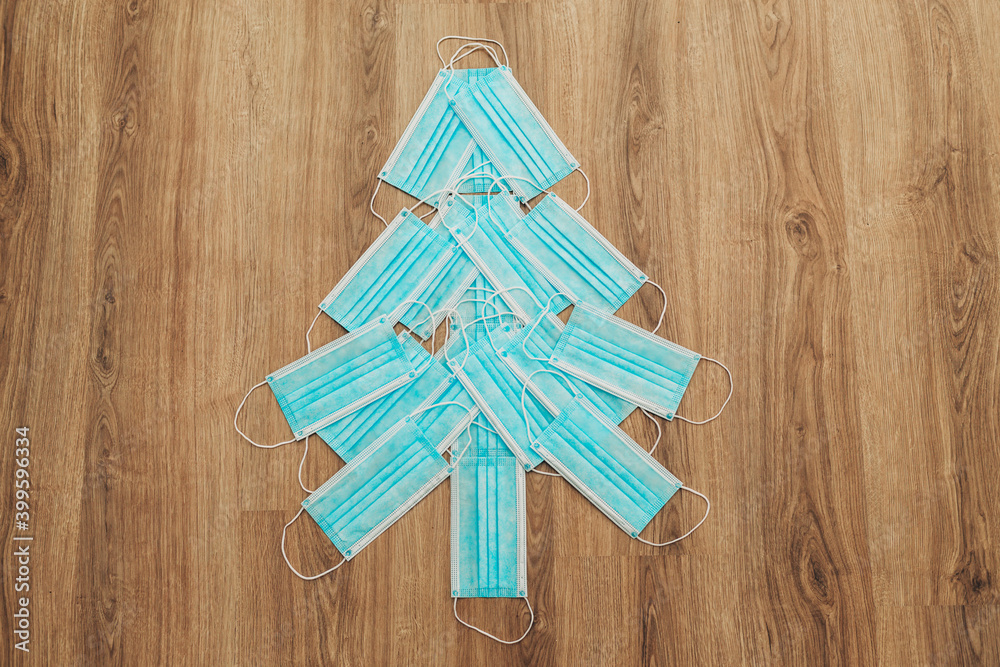 Christmas Tree Made of Medical Masks on a Brown Background Christmas Tree Made of Medical Masks on a Brown Background