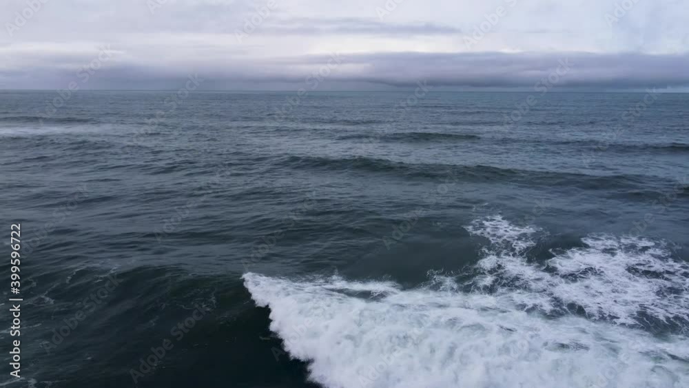 DJI FLY Aerial view winter coastal ocean line. Waves crashing on the rocks, Guincho beach on the horizon. Cascais, Portugal DJI FLY Aerial view winter coastal ocean line. Waves crashing on the rocks, Guincho beach on the horizon. Cascais, Portugal