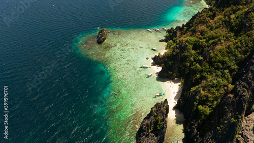 Aerial drone tropical landscape bay with beach and clear blue water surrounded by cliffs. El nido, Philippines, Palawan. Seascape with tropical rocky islands, ocean blue water. Summer and travel © Alex Traveler