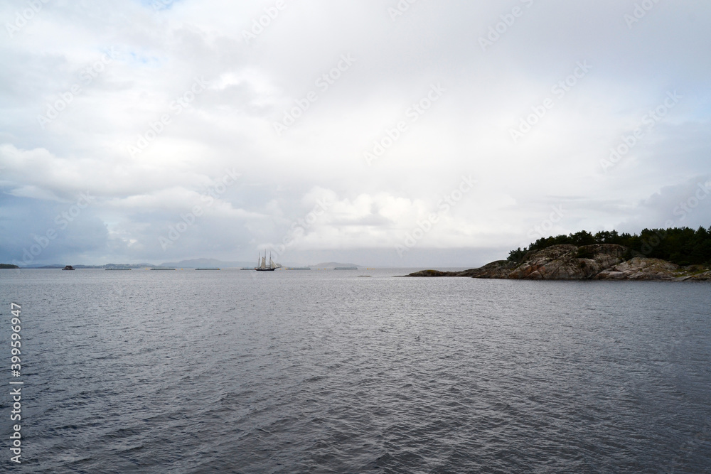 A boat trip in the Lysefjord near Stavanger. Fjords in cloudy day. A ship on the background.