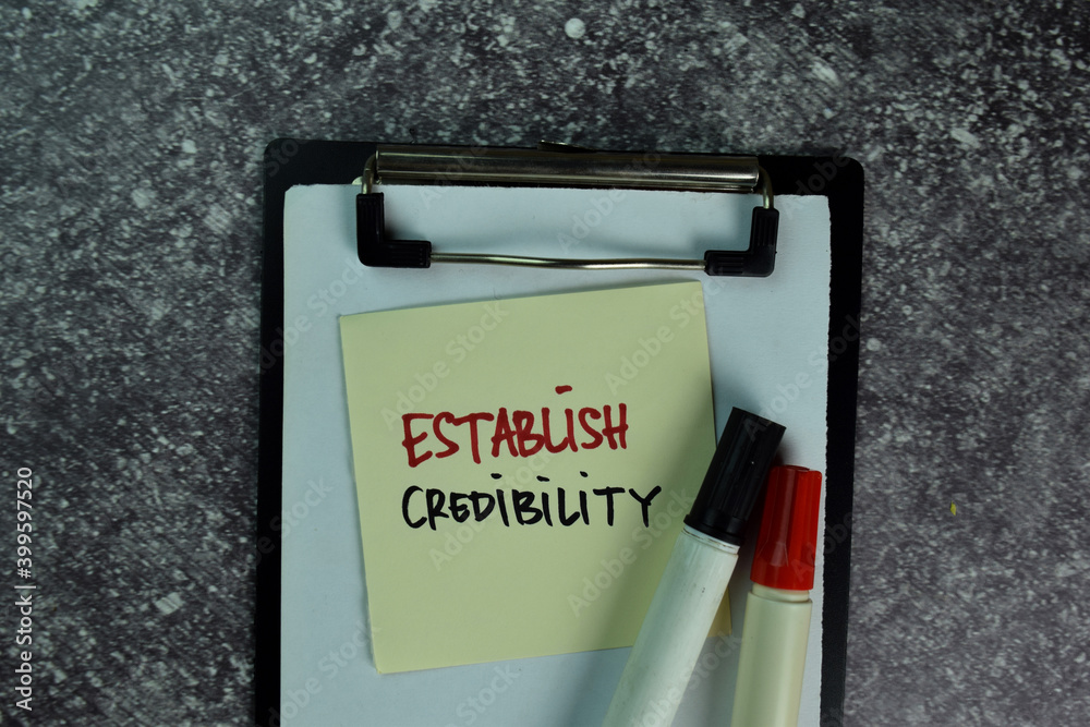 Establish Credibility write on sticky notes on the table. Business concept Establish Credibility write on sticky notes on the table. Business concept