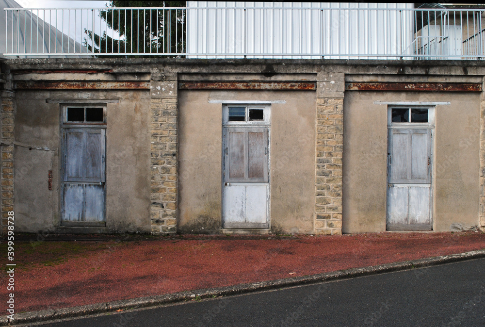 Three Identical Windows in Old Wall of Building