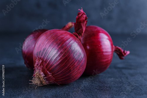 Red onions on a black table