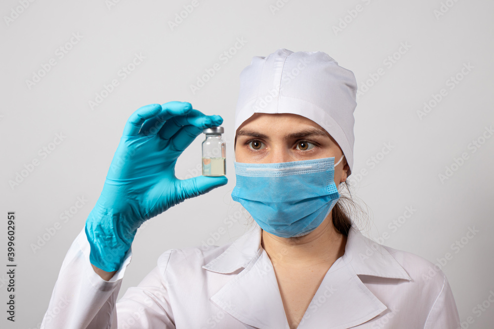 A doctor or lab technician holds a vial with a vaccine. Vaccination against tuberculosis, rabies, tetanus and other infectious diseases. Measles, Rubella, Polio, Prevention A doctor or lab technician holds a vial with a vaccine. Vaccination against tuberculosis, rabies, tetanus and other infectious diseases. Measles, Rubella, Polio, Prevention
