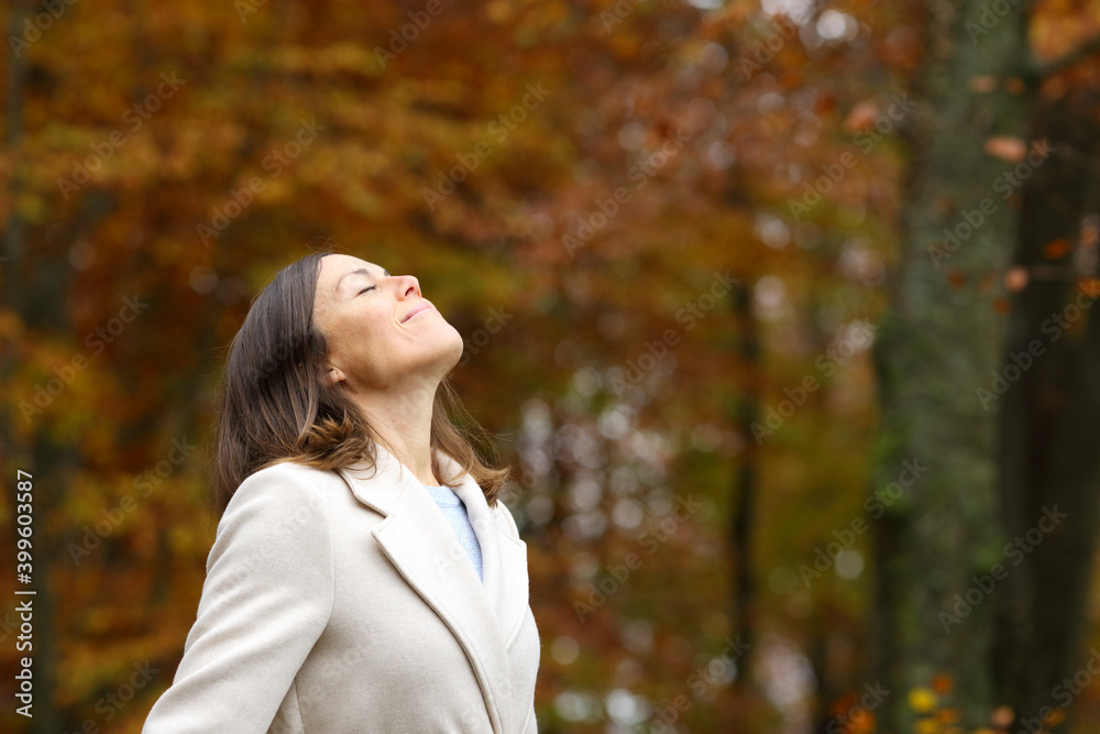 Adult woman breathing fresh air in a park in autumn Adult woman breathing fresh air in a park in autumn