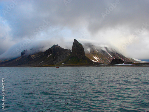 Cloudy Arctic mountains in sunny day