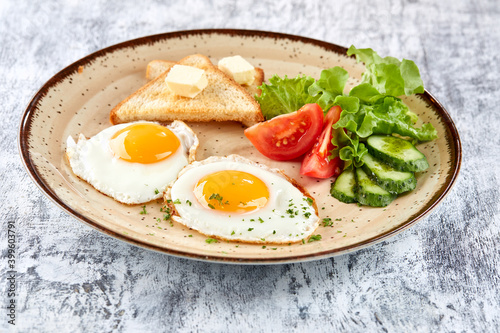 fried eggs with vegetables and toast