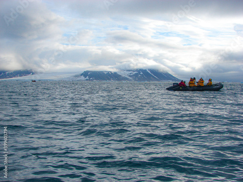 ship in the arctic sea with tourists